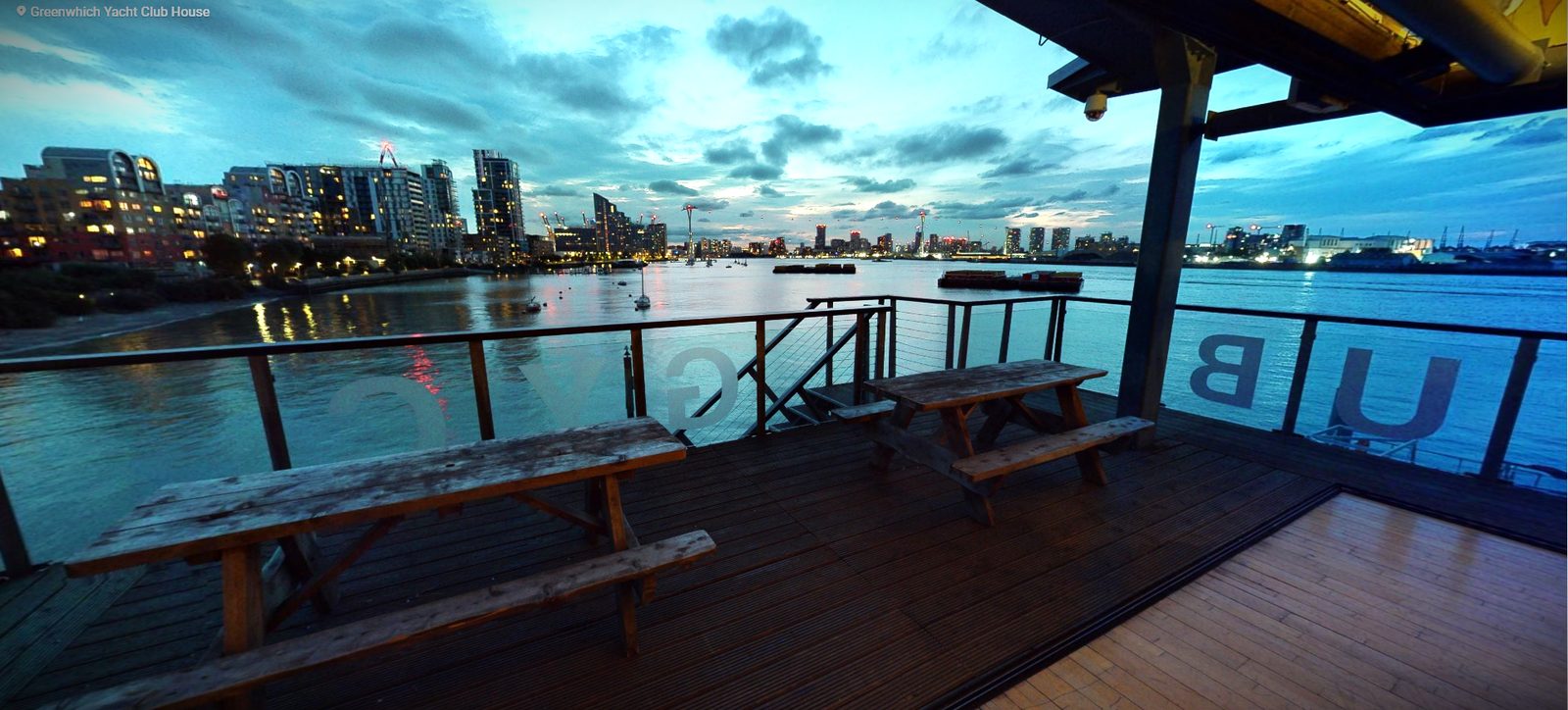 The River Rooms deck at dusk looking across the Thames to the lights of the north bank