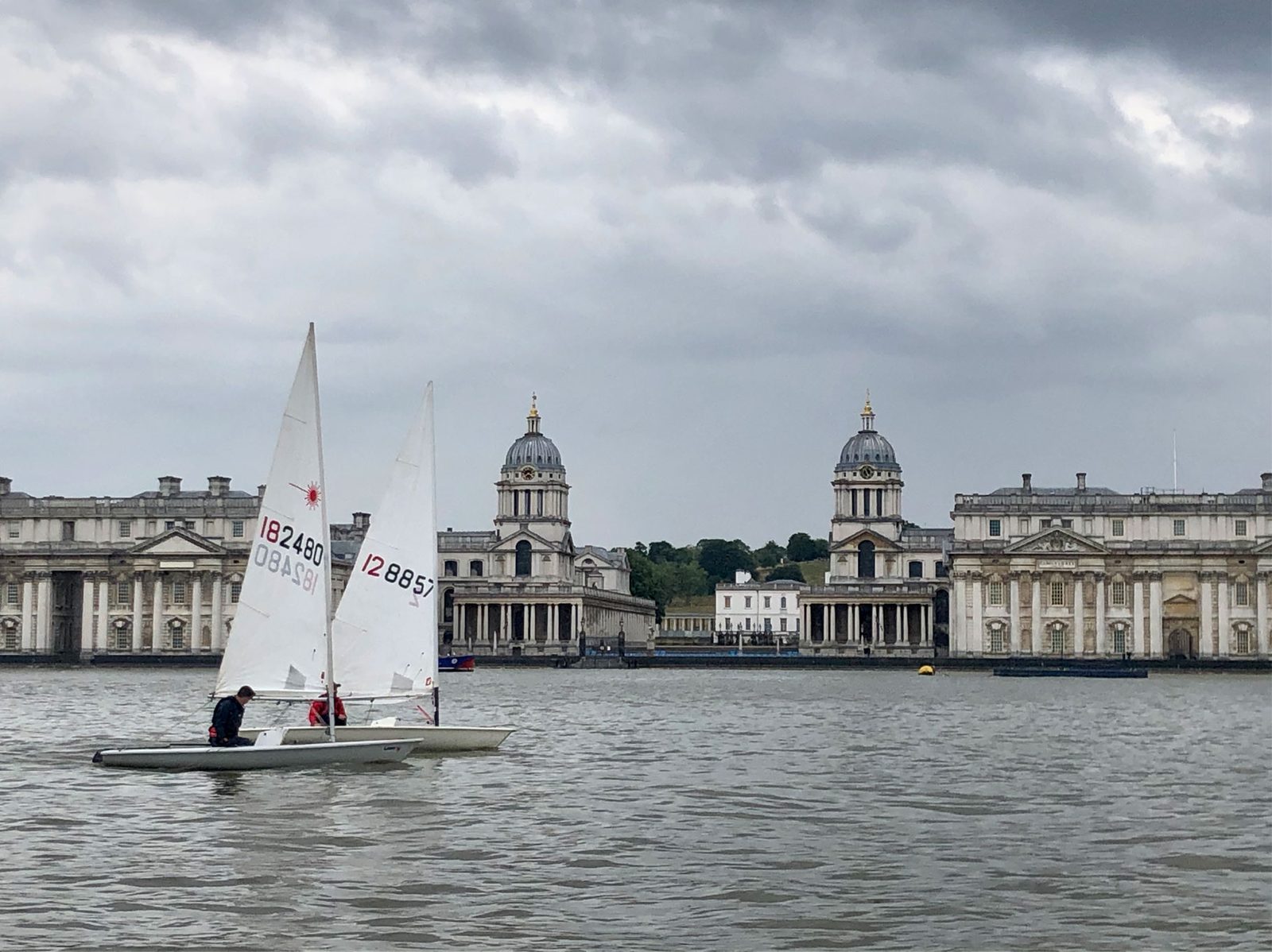 Two Lasers sailing past the Old Royal Naval College at Greenwich