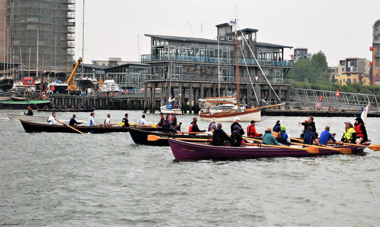 Three Thames cutters racing past the clubhouse