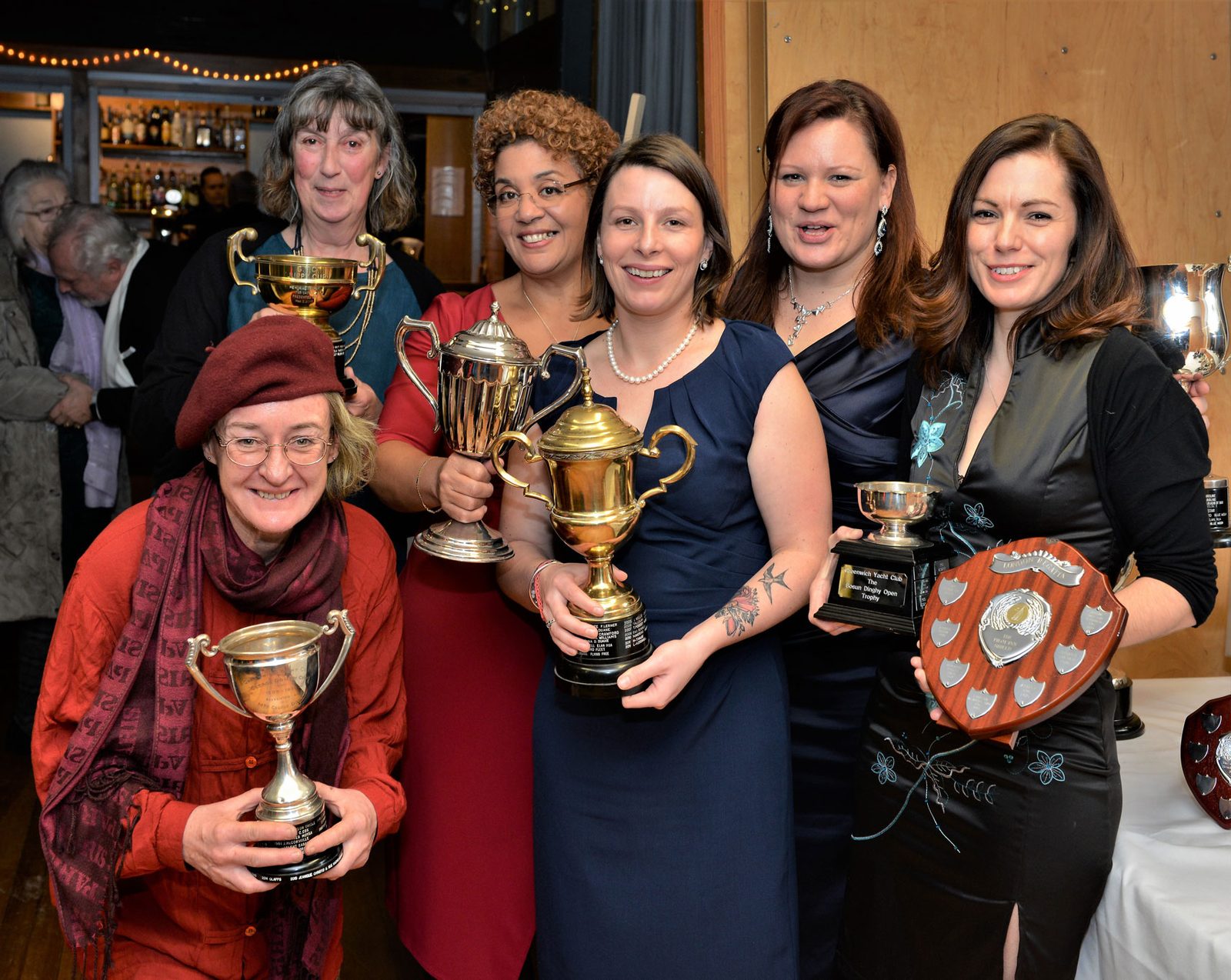 Members holding their cups and shields at the club prizegiving